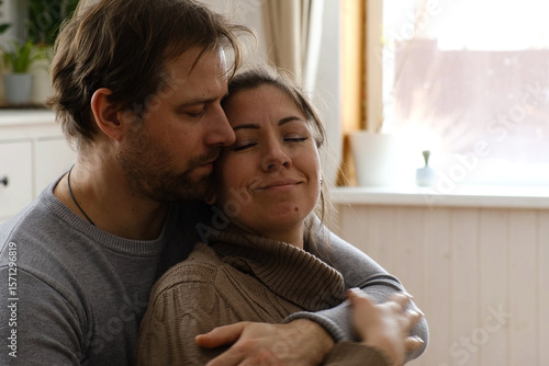 фотографія Mature couple hugging hugging each other kissing at home bedroom