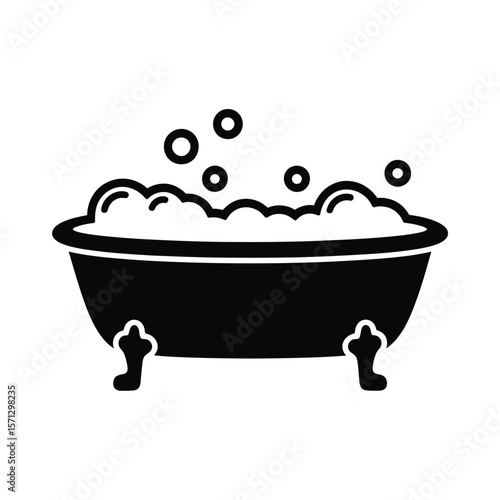 Classic clawfoot bathtub filled with bubbly foam and floating bubbles