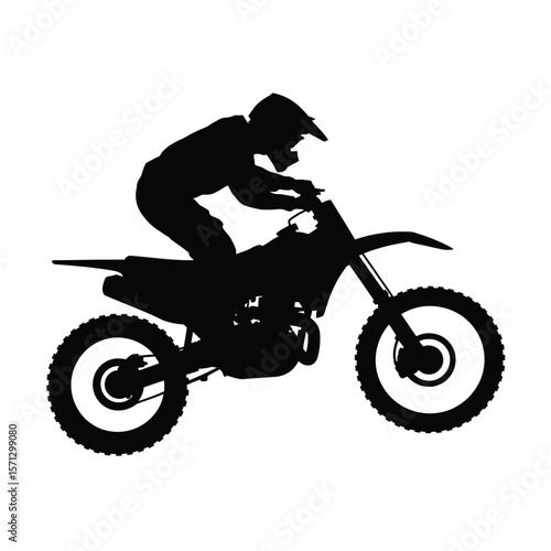 Silhouette of a motocross rider on a dirt bike in action