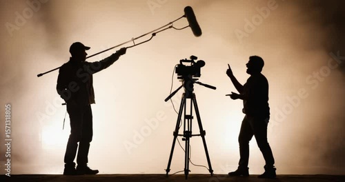 Silhouette of film crew members preparing for a shot