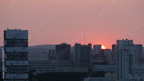 Dawn clouds over the metropolis of early winter sunset
