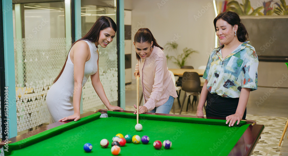 Fototapeta premium Indian happy young adult gen z woman lady hold cue stick hit ball play sport game on pool table girl female staff enjoy good break spend day time have fun joy job place