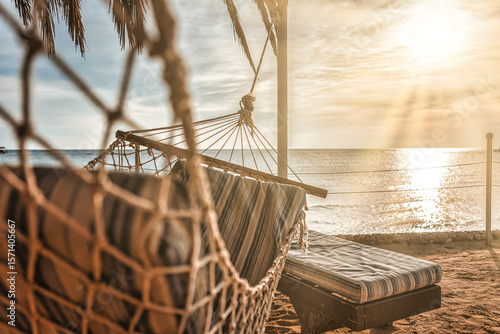 Fototapeta Naklejka Na Ścianę i Meble -  Relaxing hammock overlooking red sea sunset
