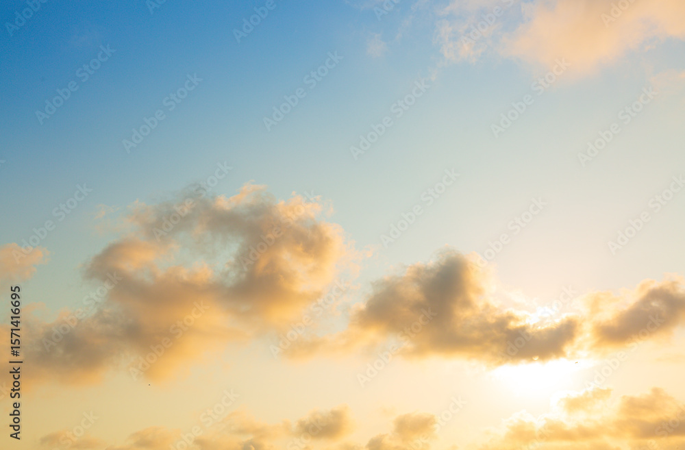 Obraz premium Orange sky and clouds in the morning,Sunset sky clouds in the evening summer with Orange, Yellow sunlight in Golden hour or morning sunrise, Horizon sky nature background.