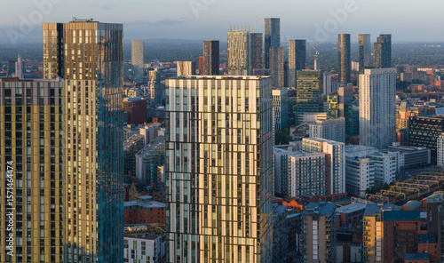 Aerial image of Manchester skyline featuring high-rise apartment buildings at Greengate during a morning sunrise. 