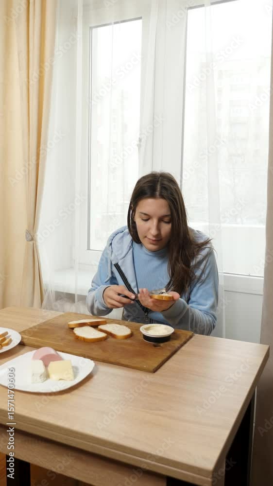 Girl preparing sandwiches with cheese and sausage. Home cooking. Girl preparing sandwiches with cheese and sausage. Home cooking.