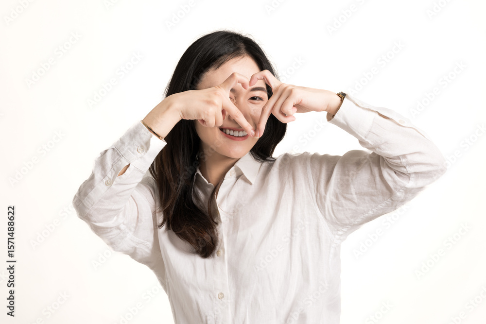 Beautiful asian young woman wear white shirt shows heart shape with her hands isolated on white background.Portrait happiness Asia woman Beautiful asian young woman wear white shirt shows heart shape with her hands isolated on white background.Portrait happiness Asia woman