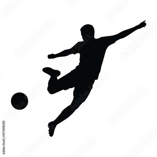 Silhouette of a soccer player kicking a ball in mid air