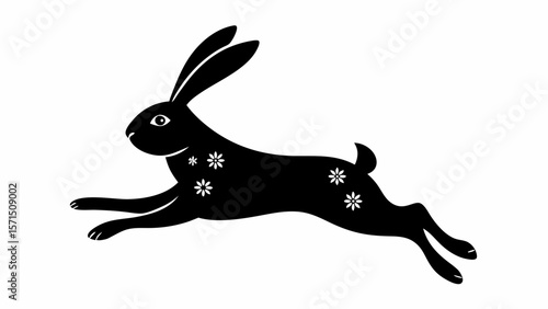 Silhouette of a black rabbit with white flower patterns in a leaping pose on a white background