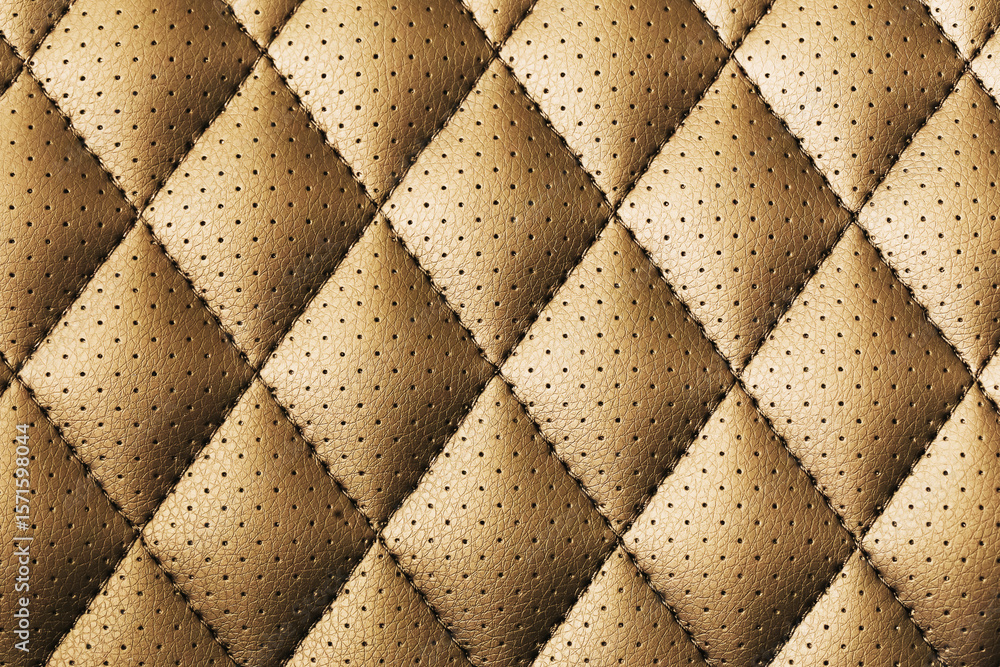 Obraz premium Brown quilted leather texture with perforated surface. Diamond pattern close-up of stitched upholstery material. Soft padded leather background for luxury furniture, interior design or car seats.
