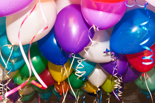 Colorful helium balloons hanging during indoor festive celebration event © Dmitry Naumov
