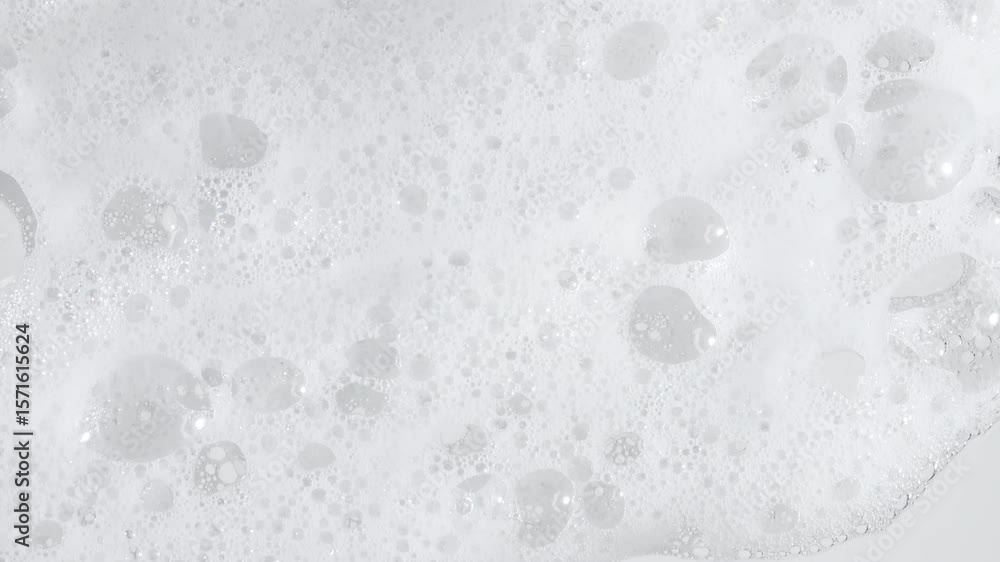 Texture of white soap foam with bubbles abstract background. Soap sud macro structure. Bathtup Soap Foam. Natural White Shampoo Bubbles Motion. High quality 4k footage