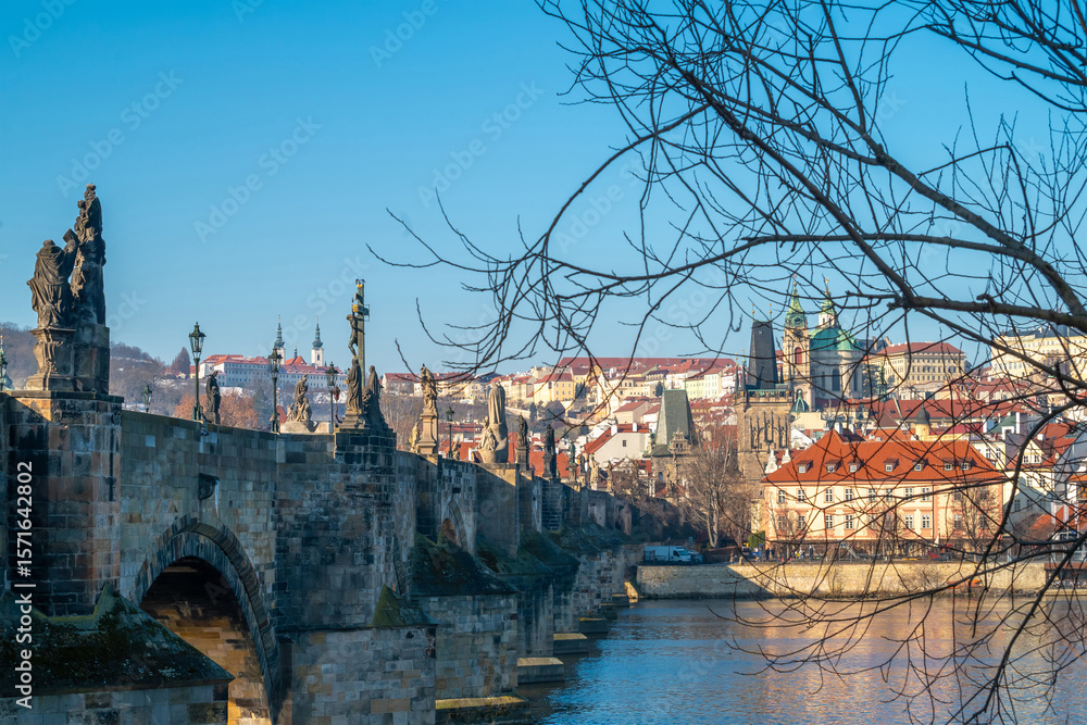 Obraz premium Prague, Czech Republic. Scenic view of Prague's iconic Charles Bridge with its historic arches and Baroque statues, overlooking the Vltava River and Lesser Town