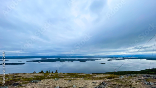 Wallpaper Mural Breathtaking view of northern lakes and archipelago from a rocky mountain summit under a dramatic overcast sky. Wide-angle shot capturing peaceful untouched nature, perfect for wilderness, travel, and Torontodigital.ca