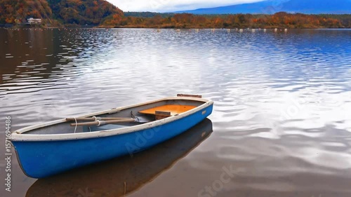 Wallpaper Mural A blue rowboat sits on a calm lake reflecting the sky Torontodigital.ca
