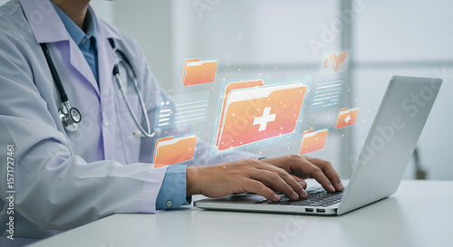 Doctor typing on laptop with digital medical records folders floating in the air around the screen