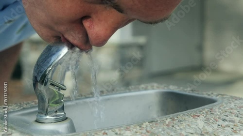 Man getting drink from drinking fountain 