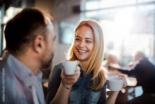 Smiling couple enjoying coffee and conversation at cafe