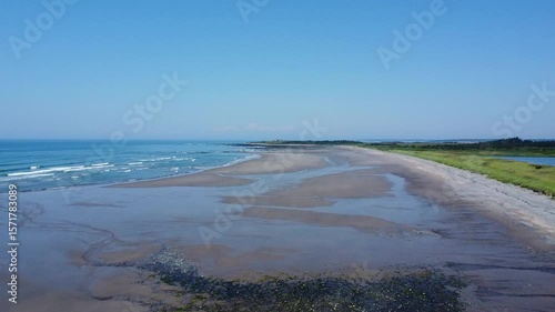 Bartlett's public beach in Digby County, Nova Scotia, Canada.  A drone fly over of the beach with wisps of mist rising.