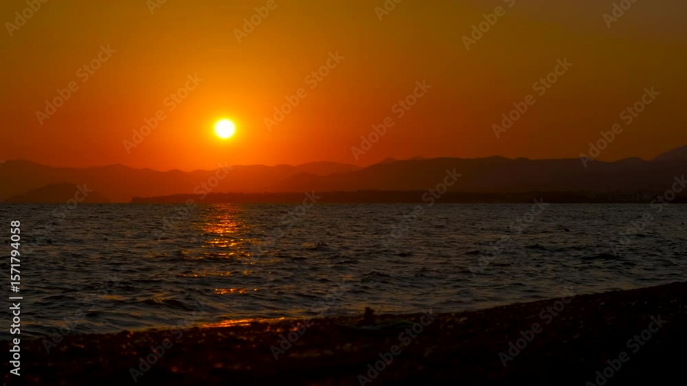 Dramatic nightfall over sea island. A dramatic sunset sky over the sea coastline in summer. Dramatic nightfall over sea island. A dramatic sunset sky over the sea coastline in summer.
