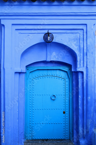 Photography Traditional powder blue painted medieval house facade and door in the historical Medina of Chefchaouen, Morocco