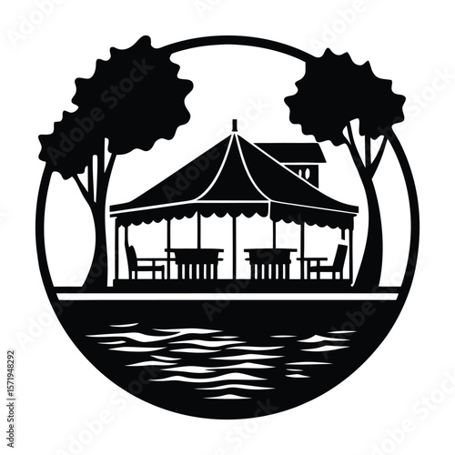 A charming lakeside restaurant silhouette glows warmly against the water, inviting guests to enjoy serene views, cozy vibes, and delightful dining under the open sky.
