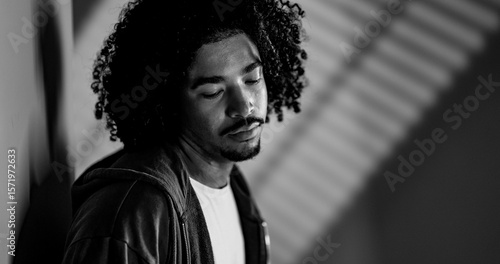 Photography Black and white portrait of a young African American man with curly hair looking