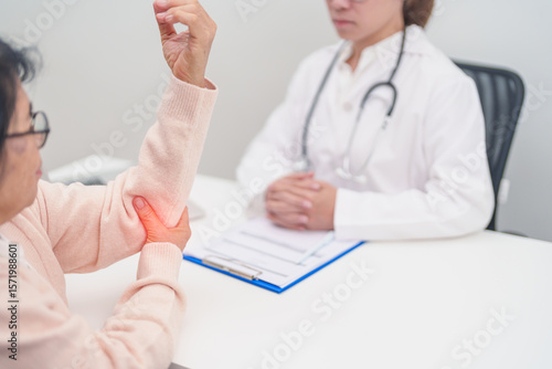 Wallpaper Mural Elderly Woman having elbow ache and consulting doctor in hospital. muscle pain due to lateral epicondylitis or tennis elbow. injury, Health and medical consultation concept Torontodigital.ca