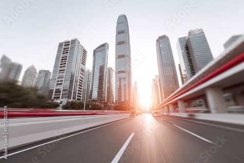 Modern skyscrapers in a city at sunset with motion blur on a highway architecture