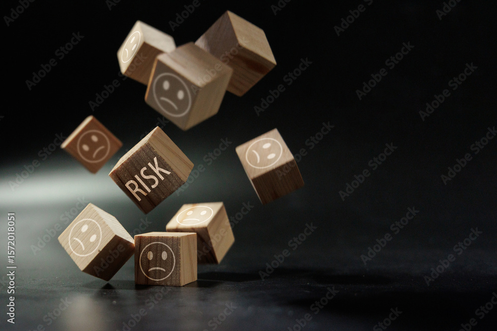 Fototapeta premium Falling Risk Blocks with Sad Faces Representing Business Uncertainty