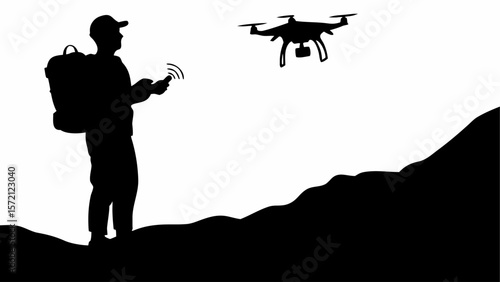 Silhouette of a man with backpack controlling a drone in flight over hilly terrain against white background