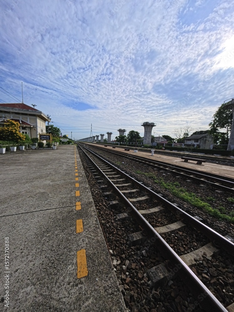 Fototapeta premium Railroad tracks at a railway station with a platform . Concept of travel, transportation 