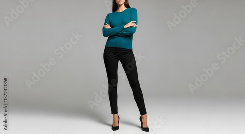 A woman in a sweater and black pants.