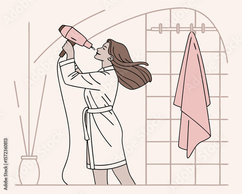 Woman drying her hair in bathroom with a hair dryer enjoying relaxing skincare routine