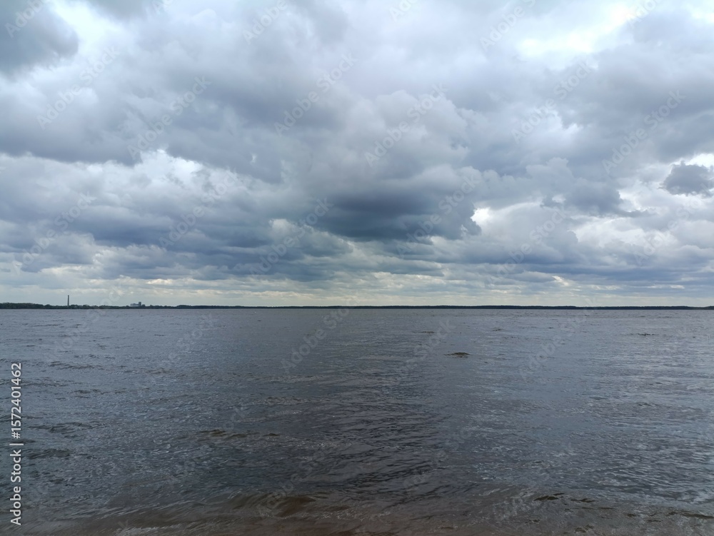 Rekyva lake during sunny day. Sunny day with white and gray clouds in sky. Wavy lake. Horizon over water. Rekyvos ezeras. Rekyva lake during sunny day. Sunny day with white and gray clouds in sky. Wavy lake. Horizon over water. Rekyvos ezeras.