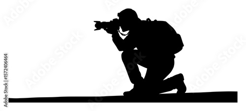 photographer silhouette kneeling with dslr camera