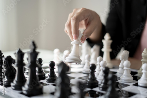 Wallpaper Mural hand of businesswoman moving chess in competition shows leadership, followers and business success strategies Torontodigital.ca