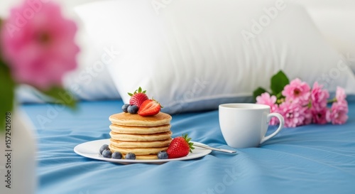 Wallpaper Mural A stack of pancakes with fresh berries and a cup of coffee are served on a blue bed with flowers Torontodigital.ca