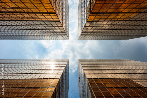 Low angle view of four buildings against blue sky, Hong Kong