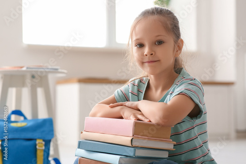 Cute little girl with books...