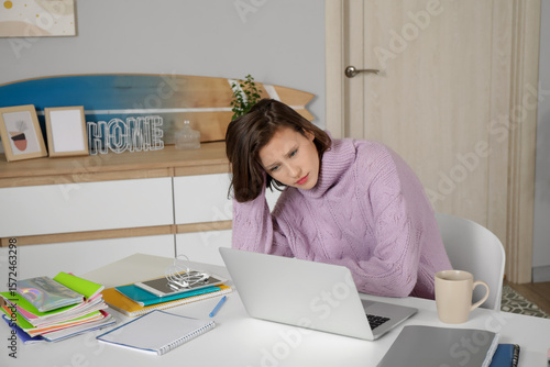 Tired female student studyi...