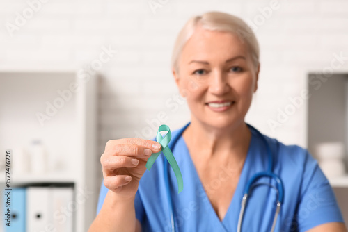 Smiling female doctor holdi...