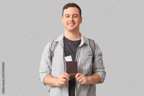 Young man holding passport ...