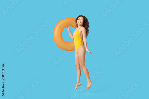 Happy young woman in yellow...