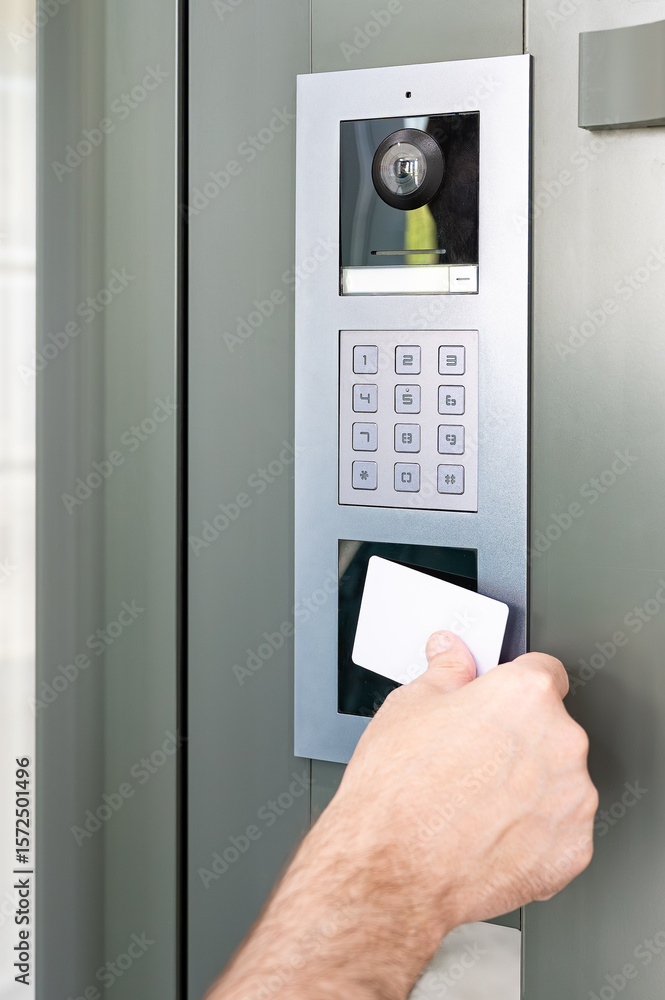 Naklejka premium Access card held close to reader on security panel for keyless identification and smart home entry