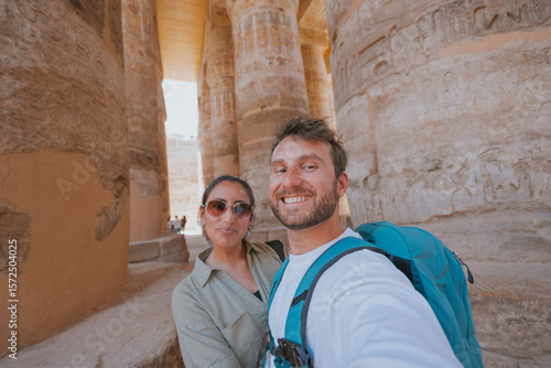 Tourists taking selfie at karnak temple complex in luxor, egypt