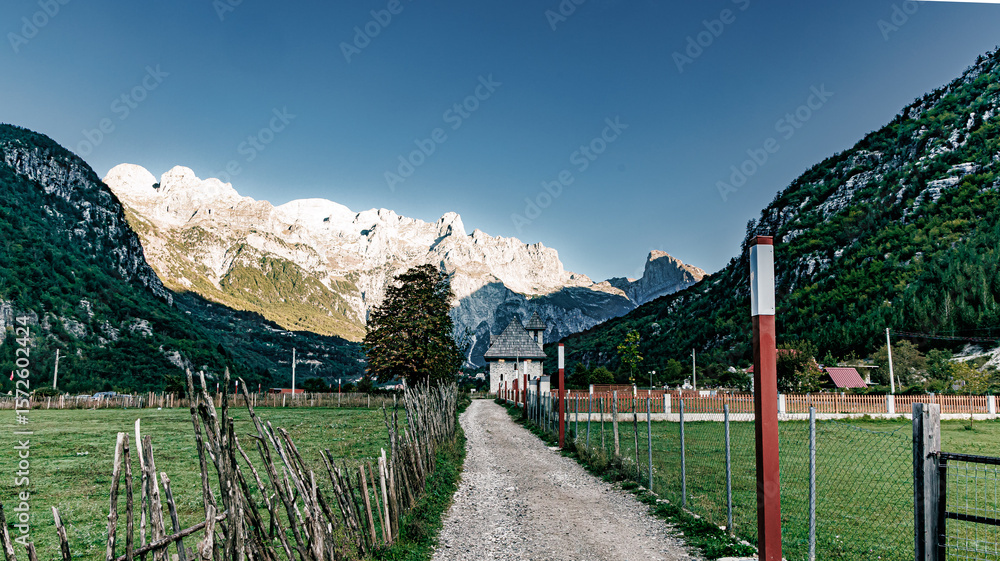 Fototapeta premium Mountains and church in theth albania sunrise in the morning 