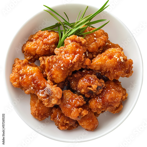 A top view of a bowl of fried chicken with sesame seeds and green garnish isolated on transparent background