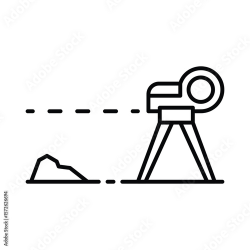 A surveyors transit on a tripod aiming at a mound of earth