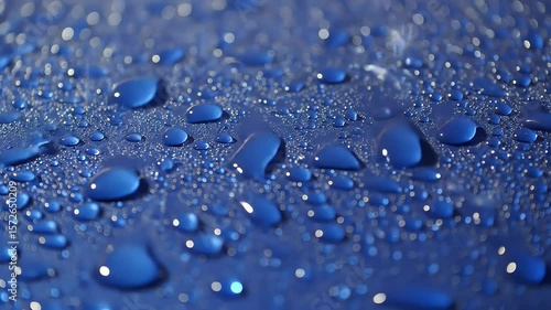Wallpaper Mural Macro close-up of water droplets beading and merging on a polished, hydrophobic blue surface, creating a clean, abstract texture Torontodigital.ca